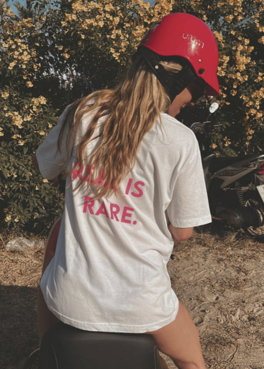 Unisex Relaxed T-Shirt “REAL IS RARE.” (Neon Pink Print)